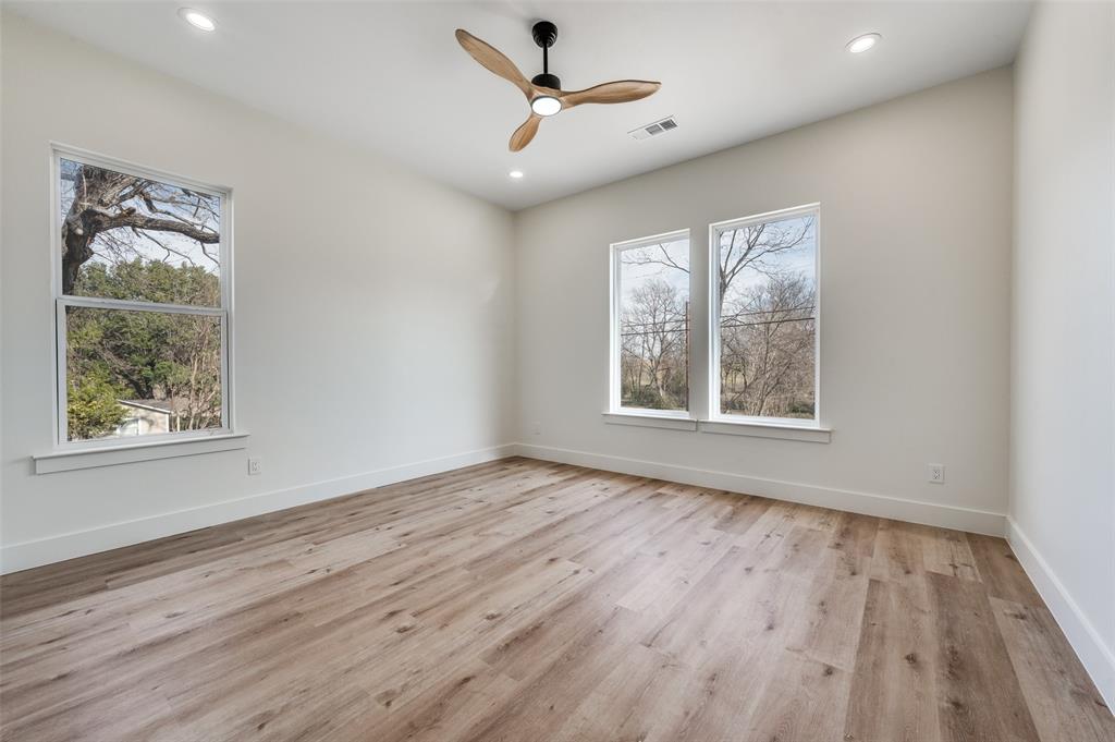 407 Bobbie Street Dallas, TX 75203 - Photo 18 of 25 a view of an empty room with wooden floor and a window
