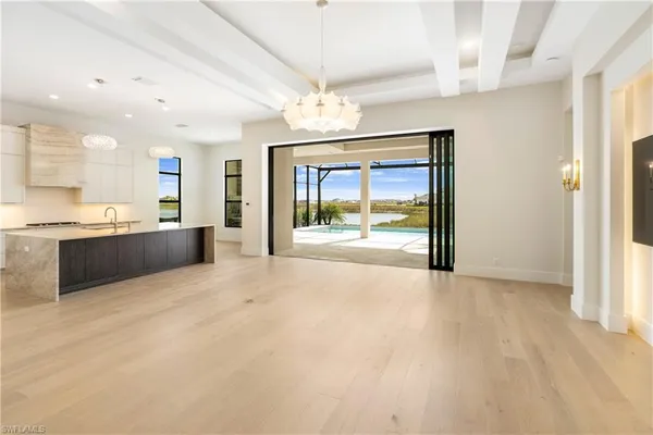 a view of an empty room with a kitchen