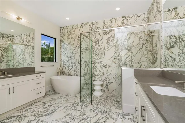 a bathroom with a granite countertop sink a toilet and shower
