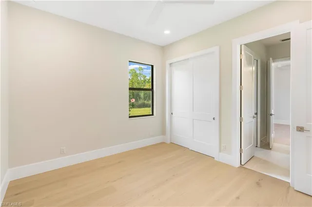 an empty room with windows and closet