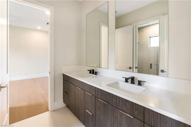 a bathroom with a double vanity sink mirror and