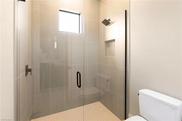 a bathroom with a shower and toilet