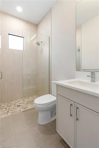 a bathroom with a toilet sink and shower
