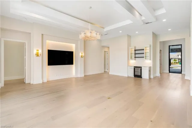 a view of an empty room with a fireplace and a window