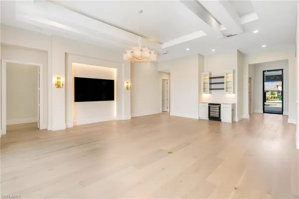 a view of an empty room with a fireplace and a window