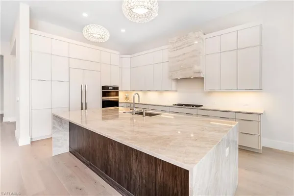 a kitchen with stainless steel appliances granite countertop a stove a sink and a refrigerator