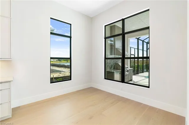 an empty room with windows and closet