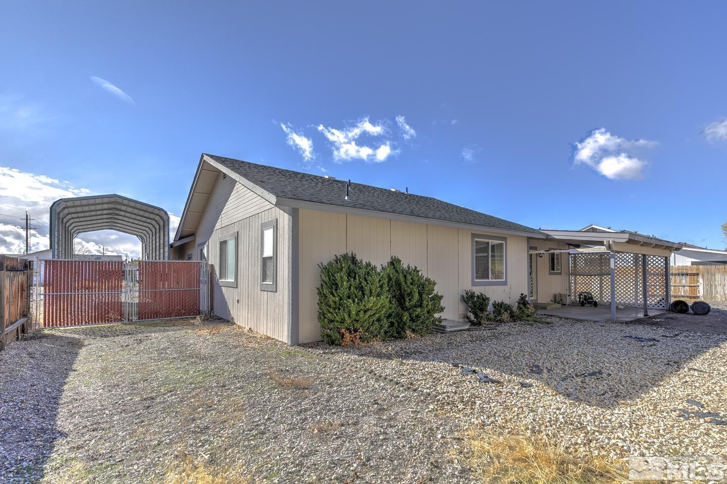 1300 Lattin Road Fallon, NV 89406 - Photo 18 of 26 a front view of a house with a yard and garage