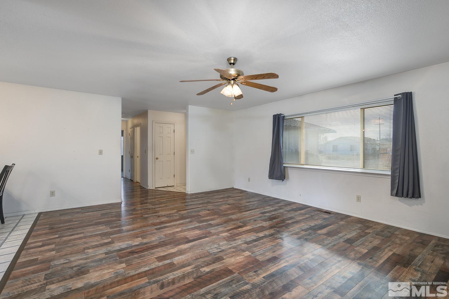 1300 Lattin Road Fallon, NV 89406 - Photo 3 of 26 a view of empty room with wooden floor and fan