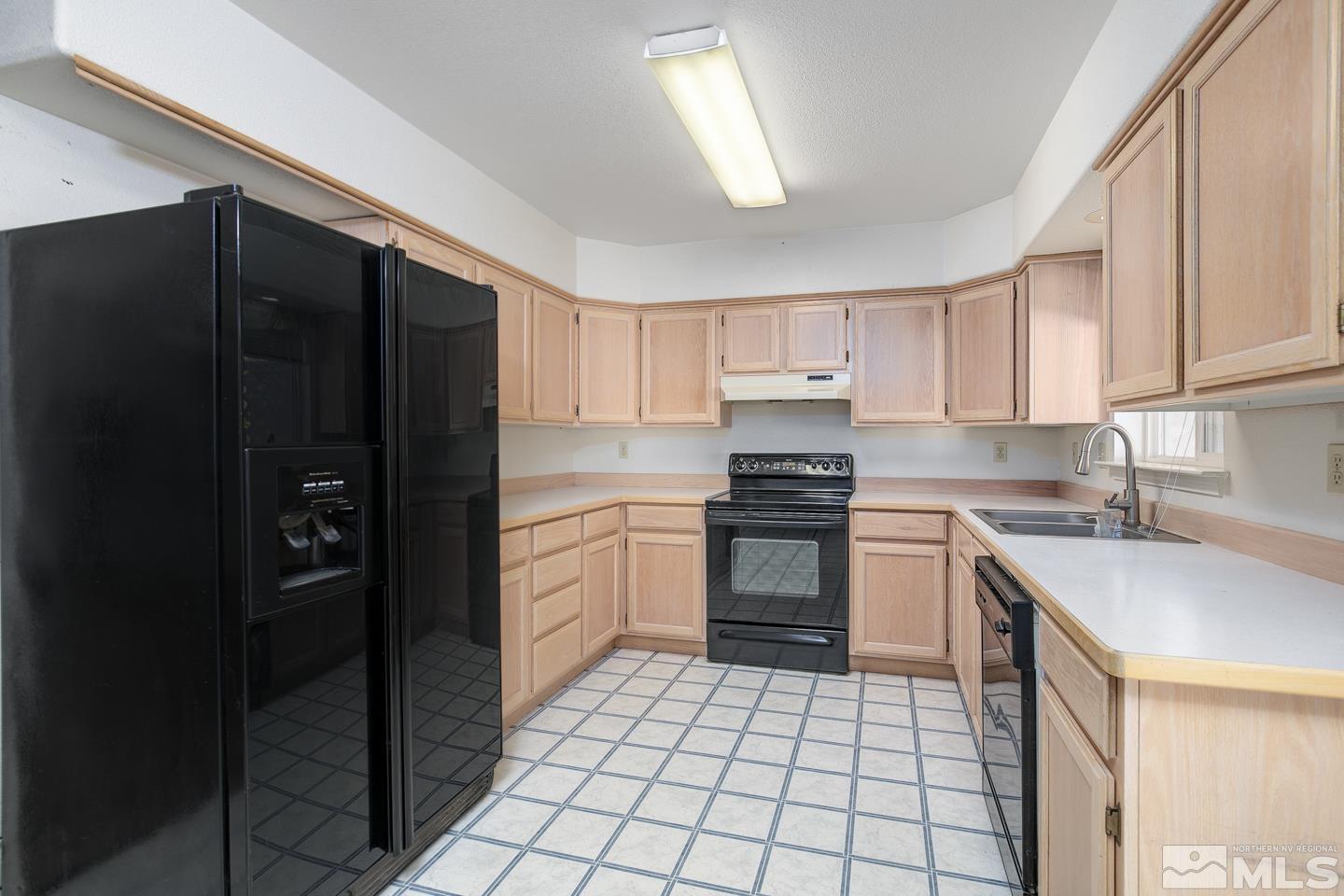 1300 Lattin Road Fallon, NV 89406 - Photo 4 of 26 a kitchen with a sink a stove and refrigerator