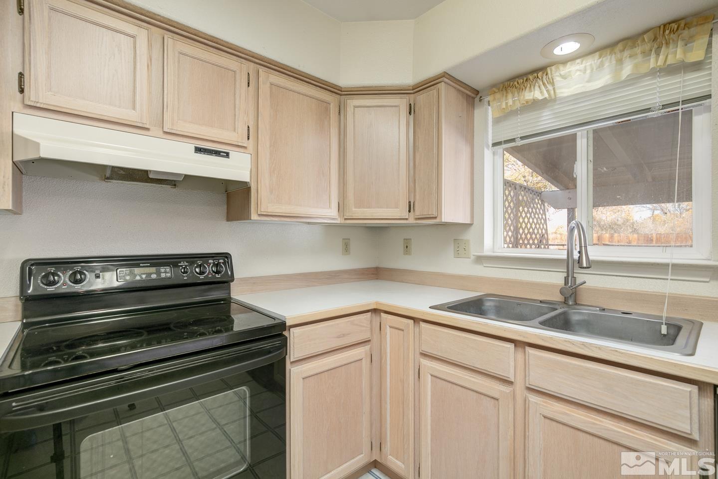 1300 Lattin Road Fallon, NV 89406 - Photo 5 of 26 a kitchen with appliances a sink and cabinets