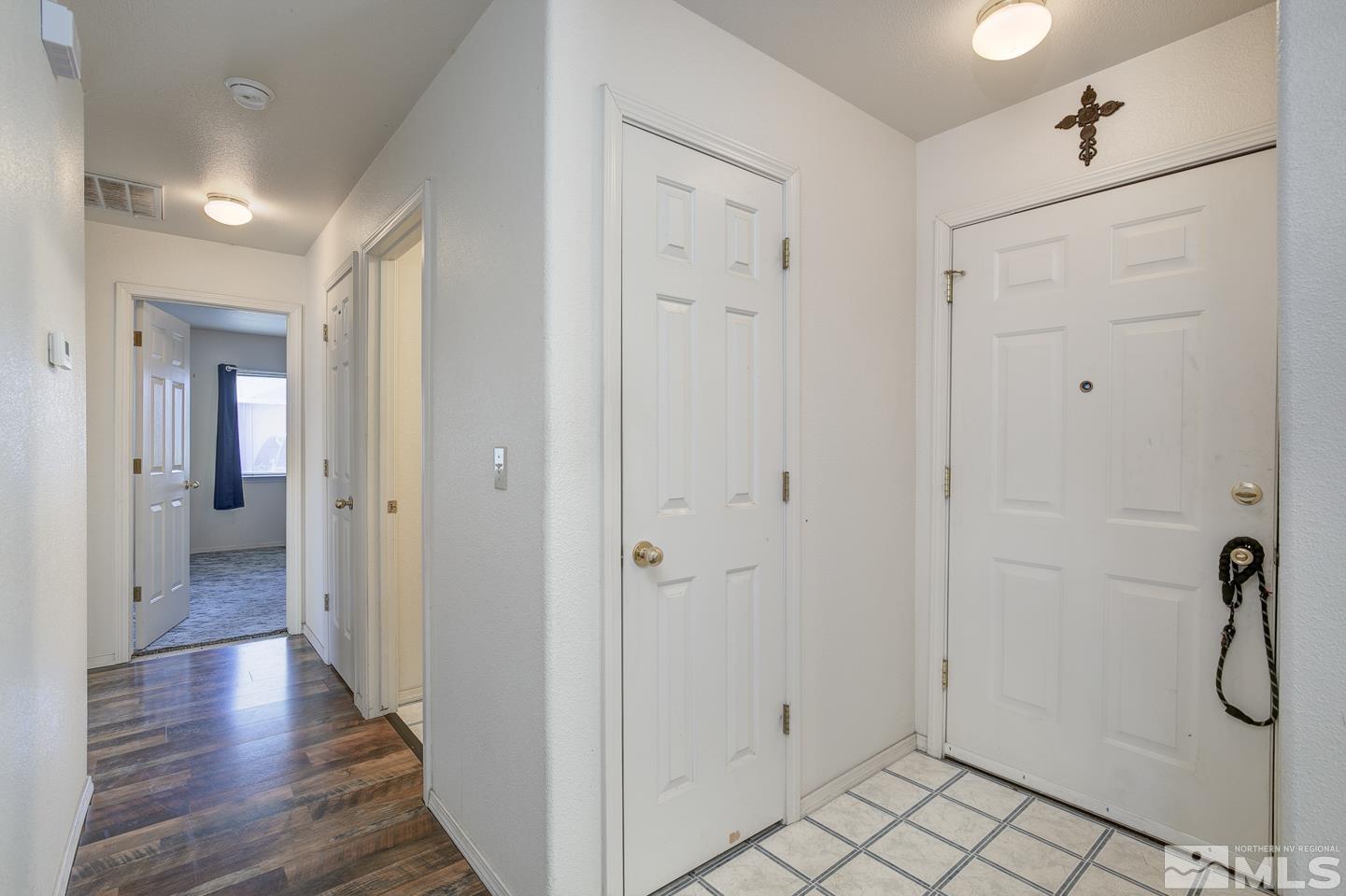 1300 Lattin Road Fallon, NV 89406 - Photo 8 of 26 a view of a hallway with wooden floor