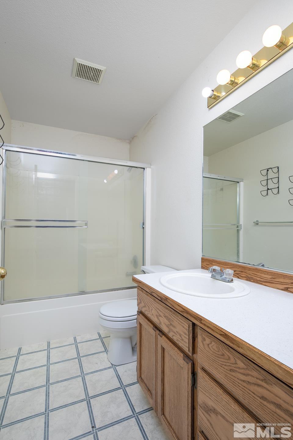 1300 Lattin Road Fallon, NV 89406 - Photo 10 of 26 a bathroom with a sink a toilet and shower