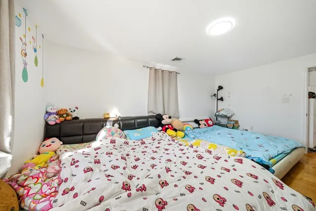 a bedroom with a bed and a dresser in it