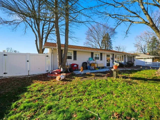 a view of a house with backyard porch and sitting area