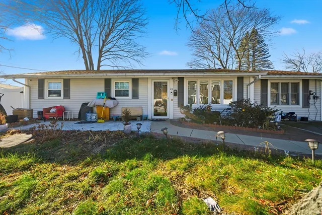 a front view of house with yard and outdoor seating