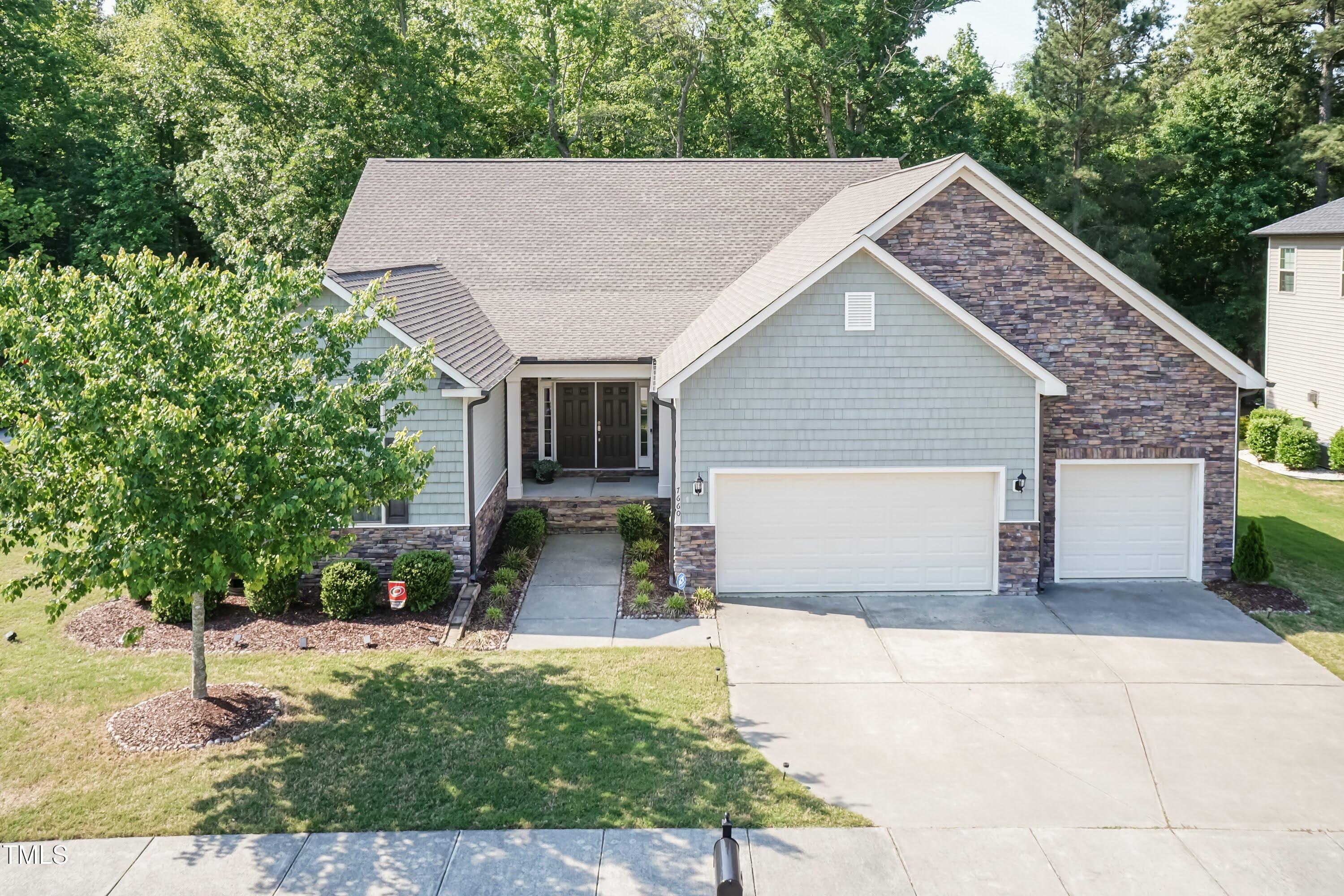 7660 Channery Way Raleigh, NC 27616 - Photo 1 of 42 a front view of a house with a yard and garage