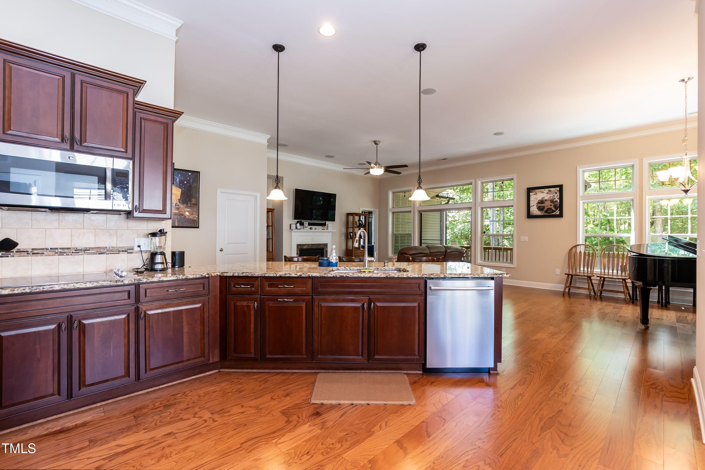 7660 Channery Way Raleigh, NC 27616 - Photo 12 of 42 a kitchen with stainless steel appliances granite countertop wooden floors and sink