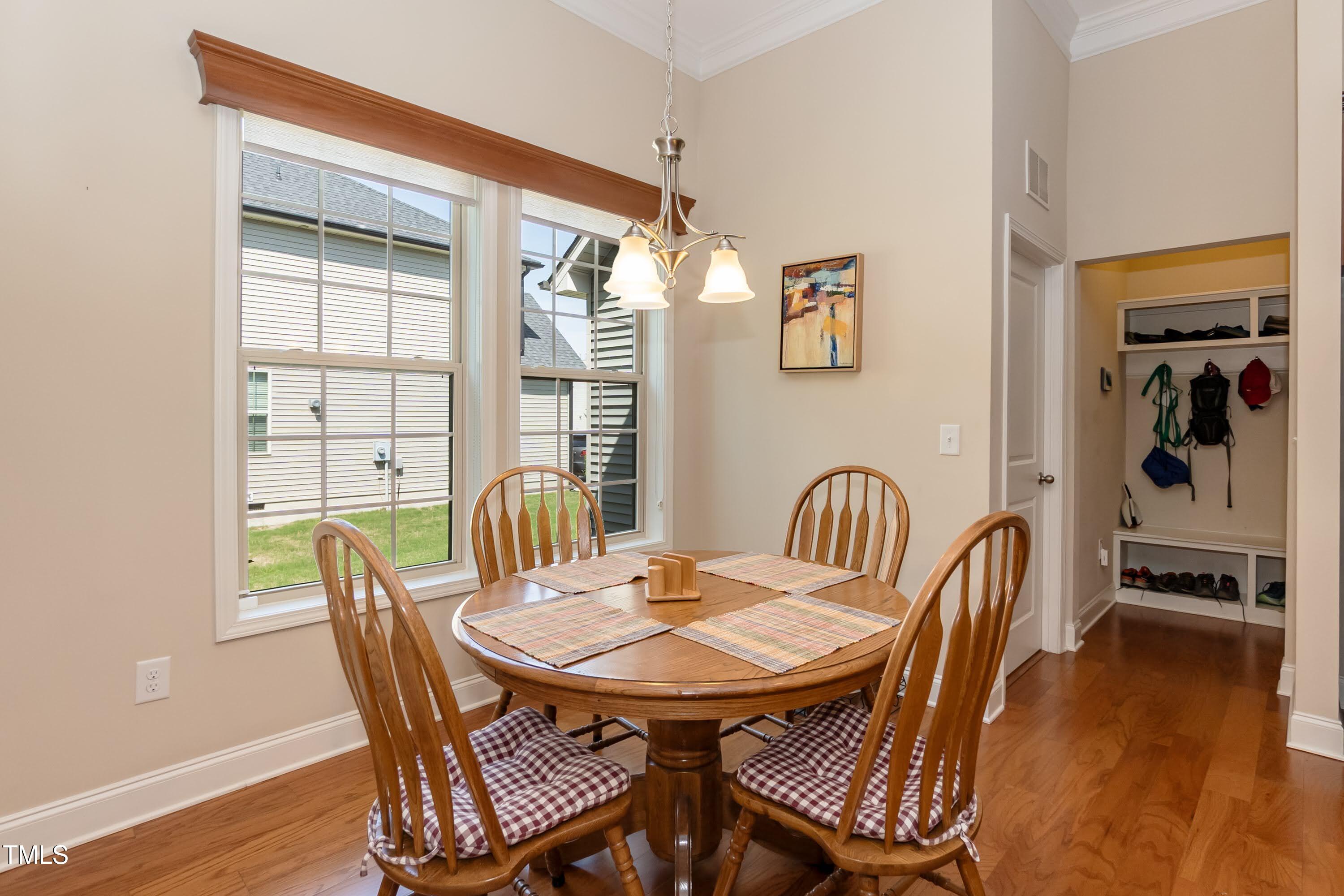 7660 Channery Way Raleigh, NC 27616 - Photo 13 of 42 a view of a dining room with furniture and wooden floor