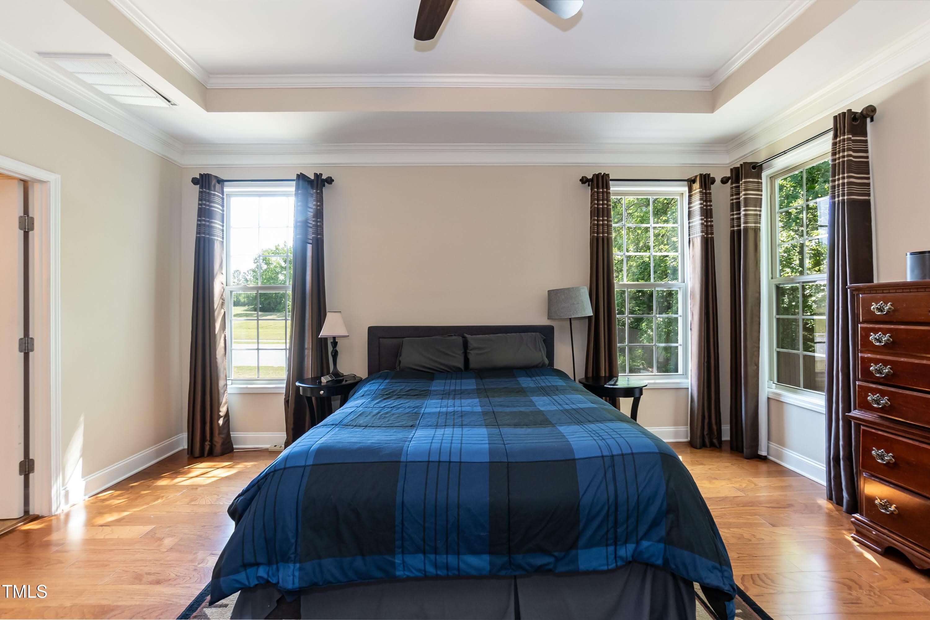7660 Channery Way Raleigh, NC 27616 - Photo 16 of 42 a bedroom with a bed and wooden floor