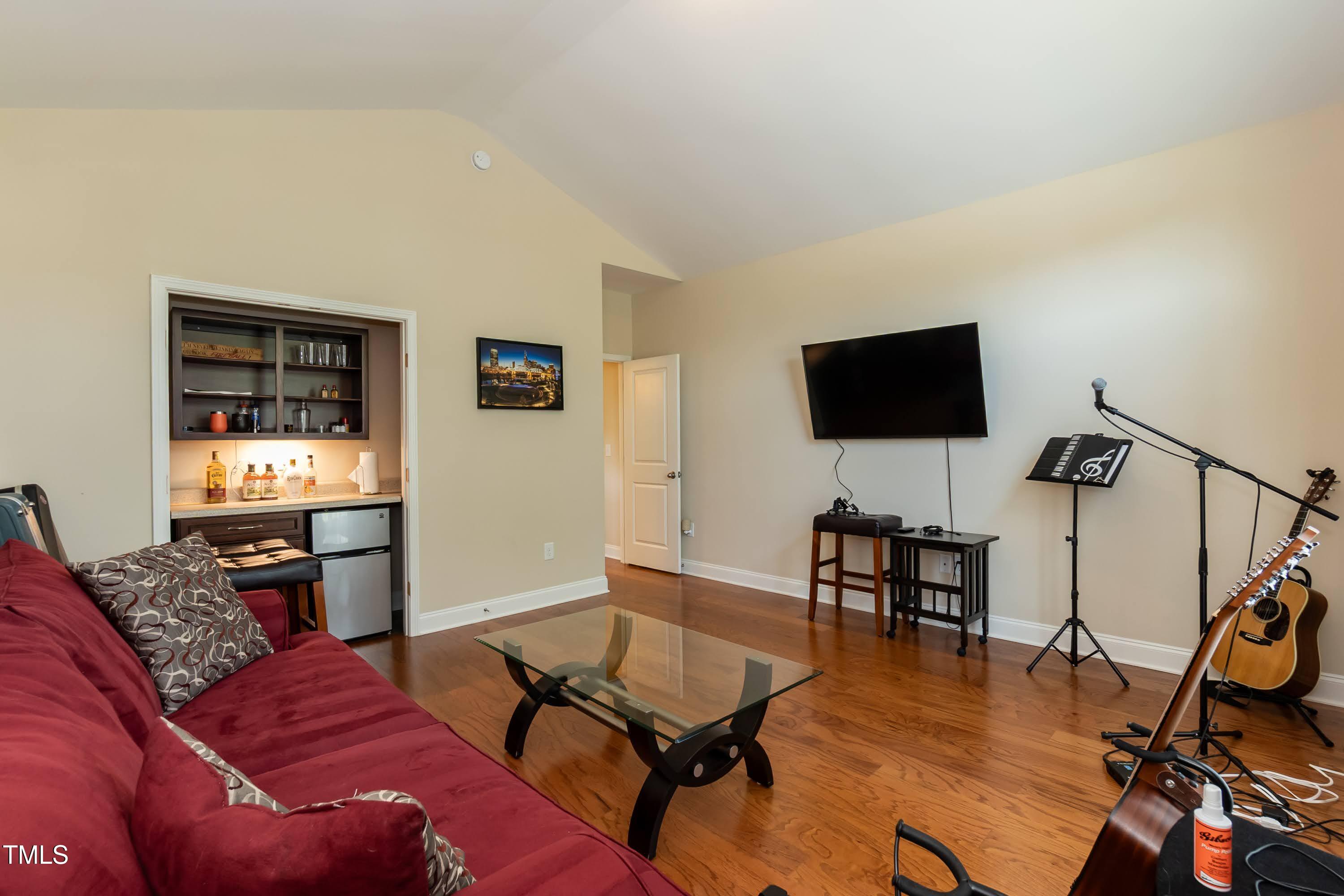 7660 Channery Way Raleigh, NC 27616 - Photo 21 of 42 a living room with furniture and a flat screen tv