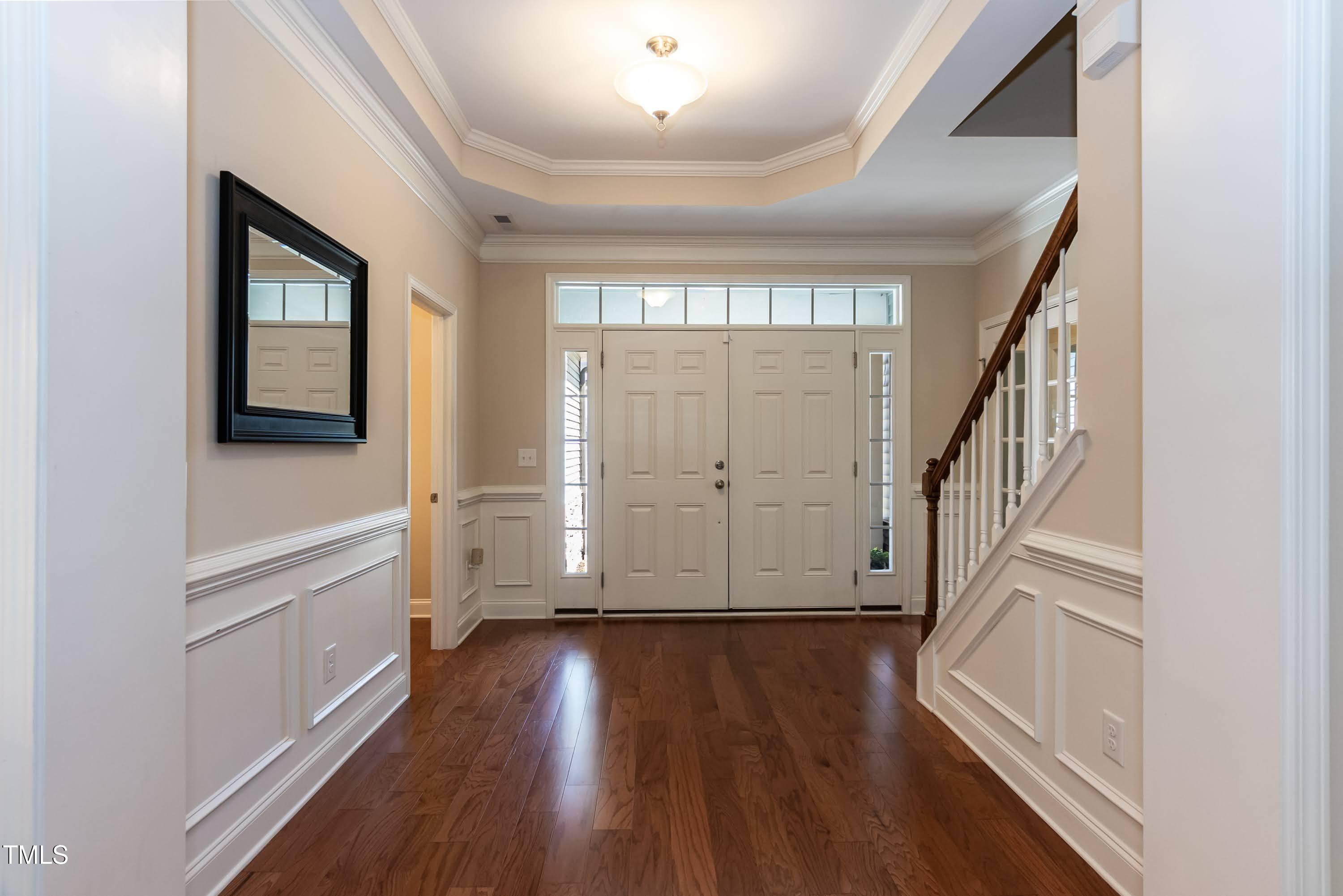 7660 Channery Way Raleigh, NC 27616 - Photo 3 of 42 a view of entryway with wooden floor and stairs