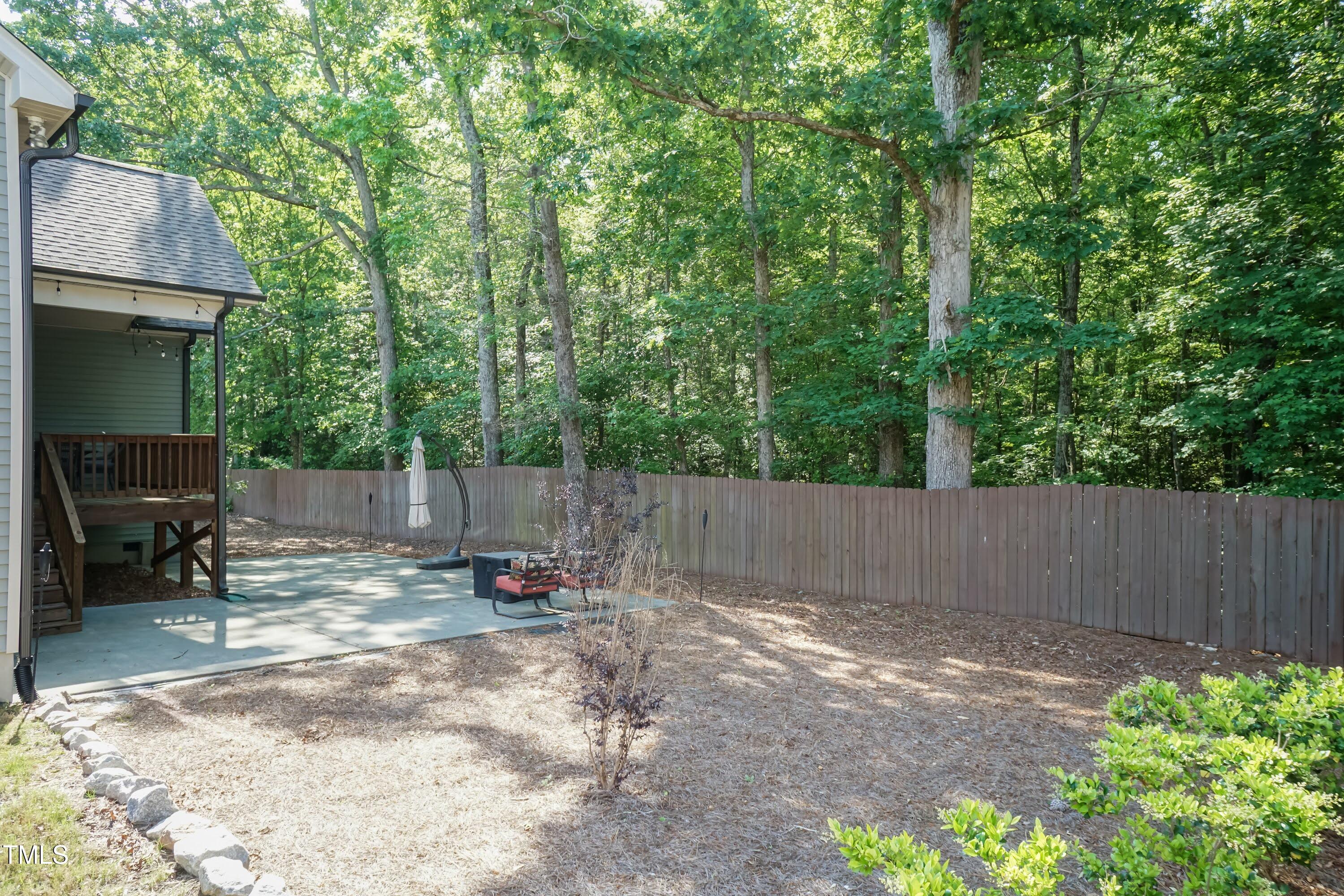 7660 Channery Way Raleigh, NC 27616 - Photo 32 of 42 a backyard of a house with chairs and a small yard