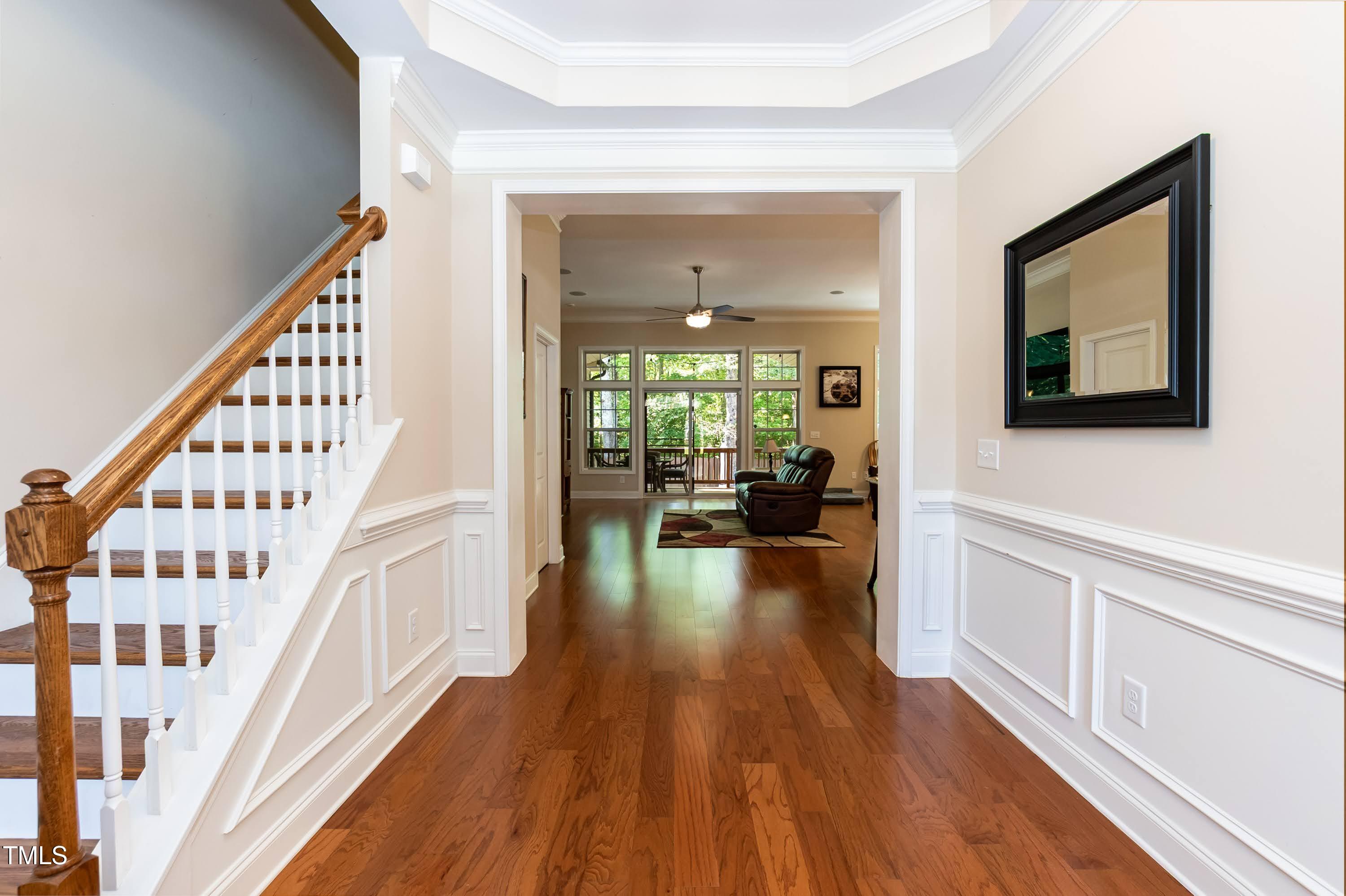 7660 Channery Way Raleigh, NC 27616 - Photo 4 of 42 a view of a hallway view with wooden floor and furniture