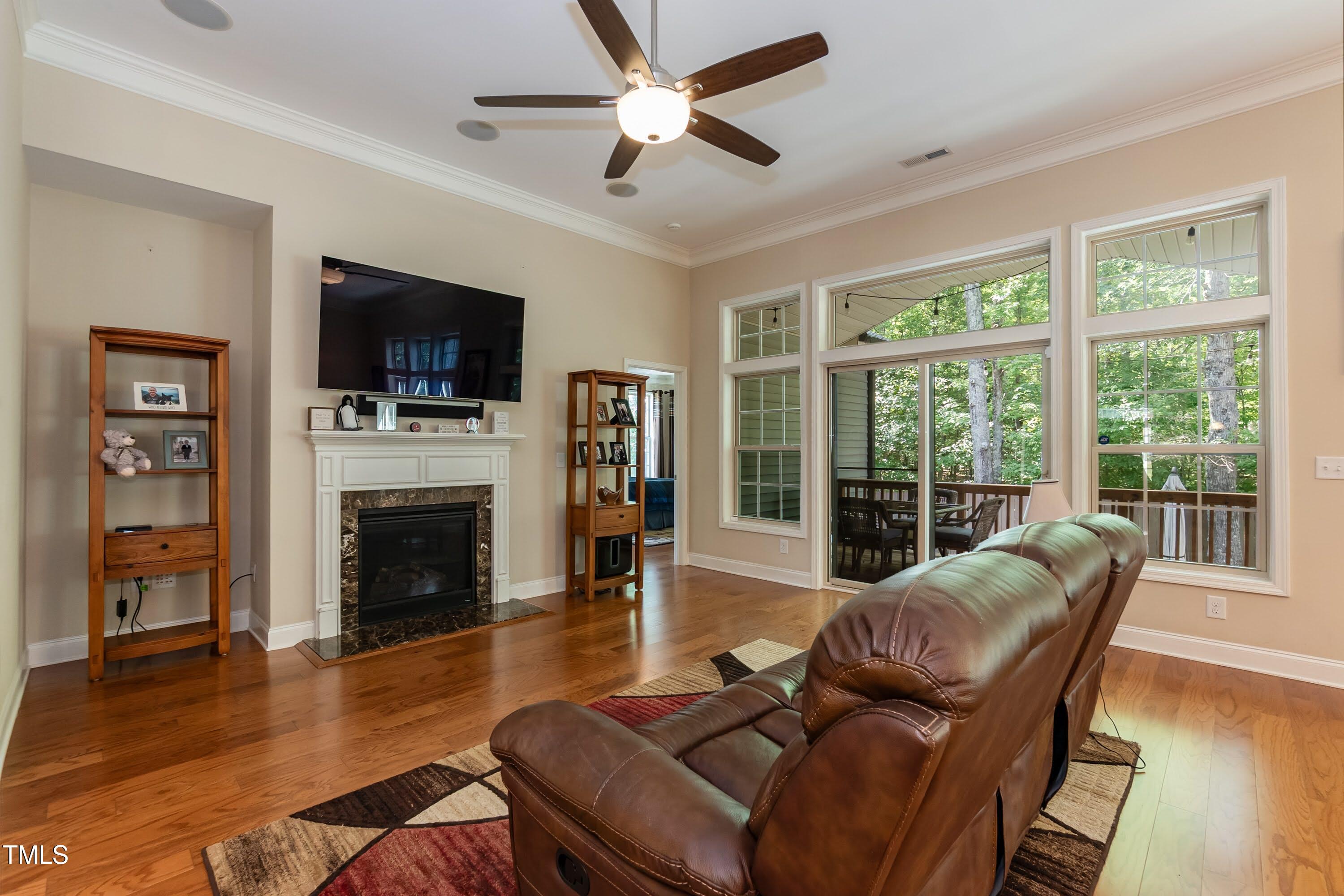 7660 Channery Way Raleigh, NC 27616 - Photo 5 of 42 a living room with furniture a flat screen tv and a fireplace