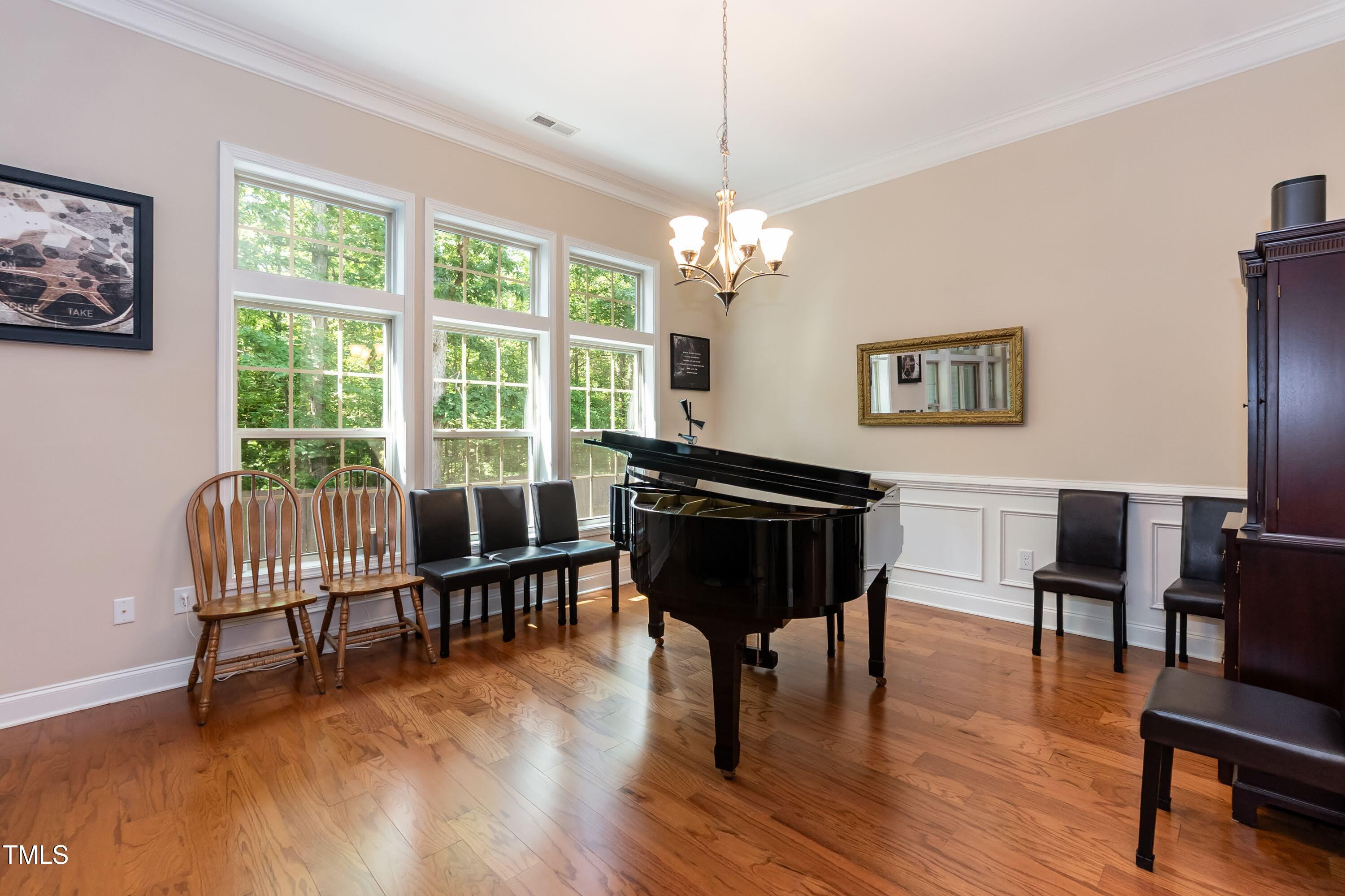 7660 Channery Way Raleigh, NC 27616 - Photo 8 of 42 a view of a livingroom with furniture a window and wooden floor