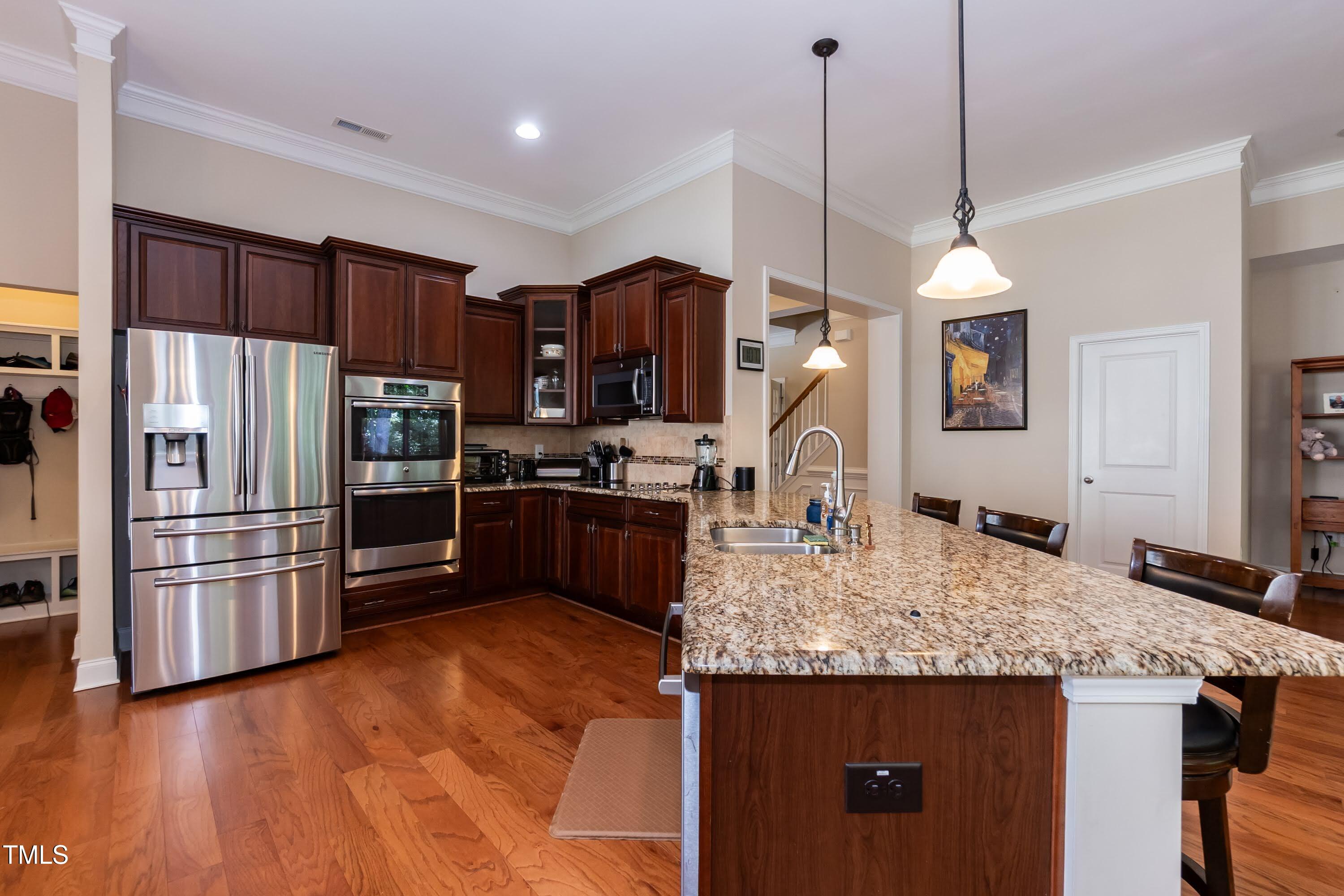 7660 Channery Way Raleigh, NC 27616 - Photo 9 of 42 a kitchen with kitchen island a counter top space appliances and a center island