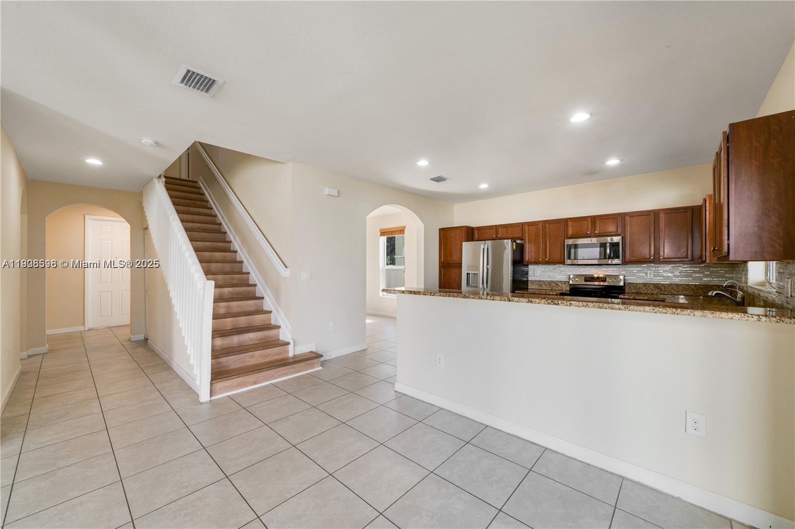 16946 Southwest 90th Terrace Circle Miami, FL 33196 - Photo 11 of 36 a view of kitchen with stainless steel appliances refrigerator and stove