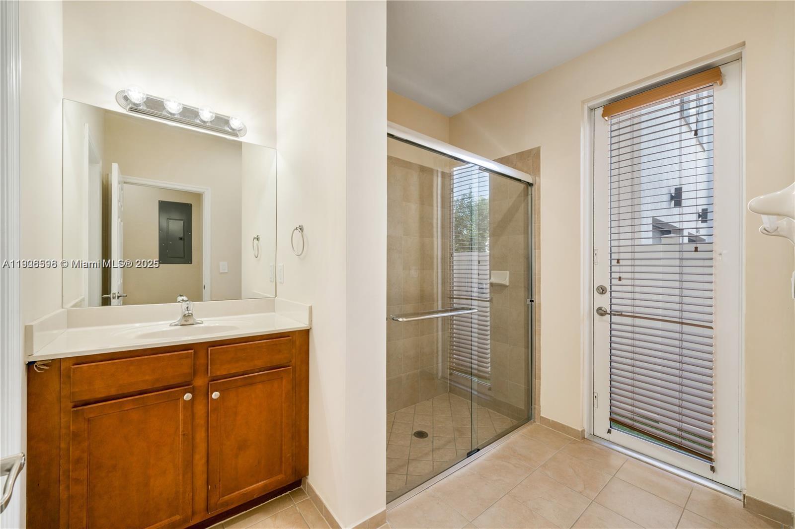 16946 Southwest 90th Terrace Circle Miami, FL 33196 - Photo 15 of 36 a bathroom with a shower sink and mirror