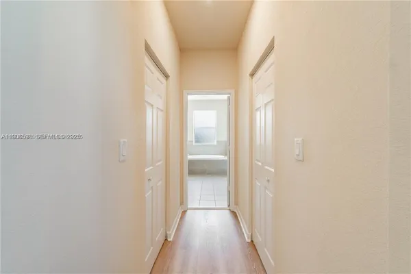 a bathroom with a bathtub shower sink and mirror