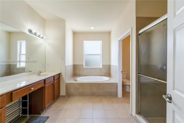 a bathroom with a shower and a sink