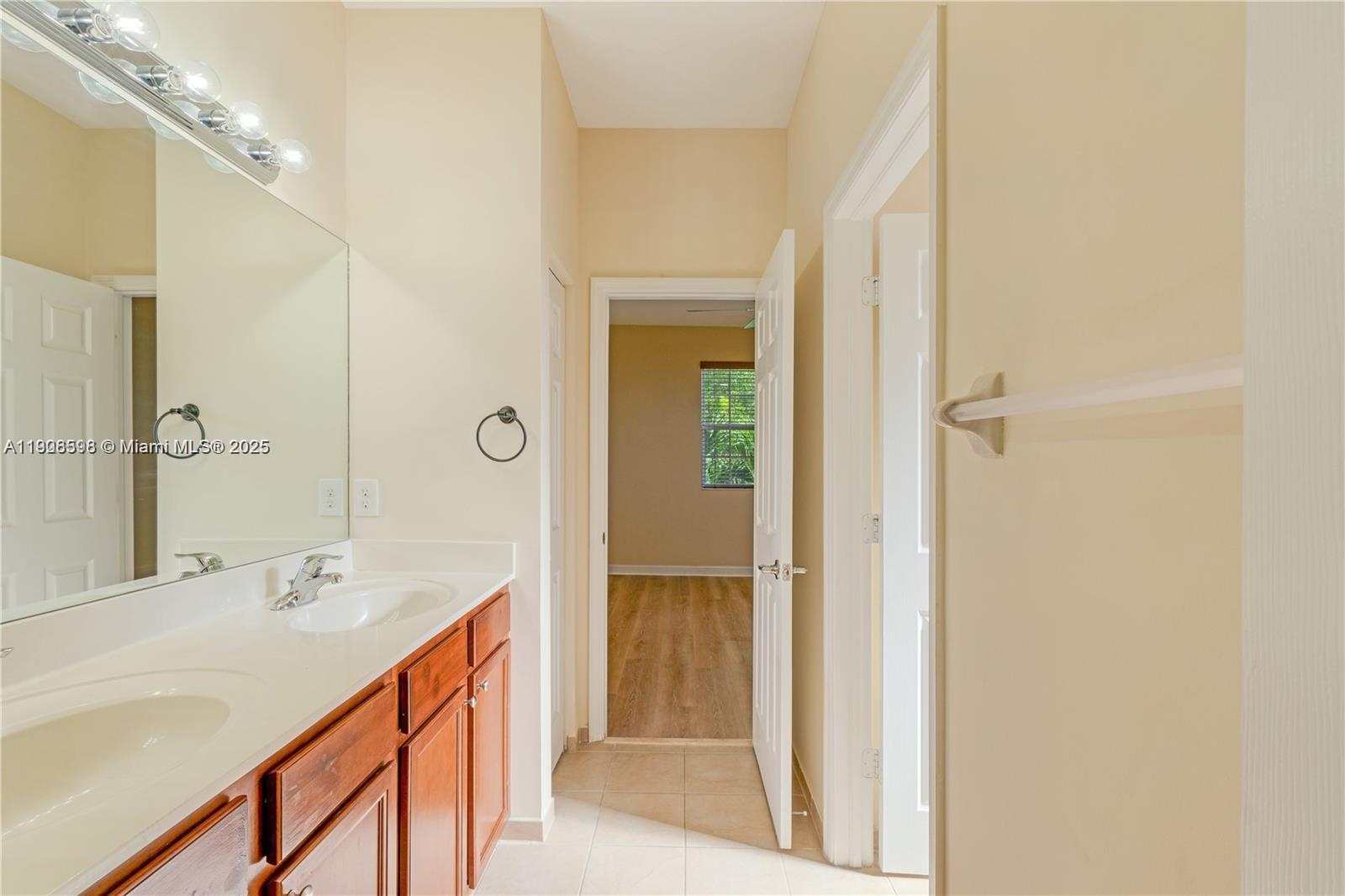 16946 Southwest 90th Terrace Circle Miami, FL 33196 - Photo 23 of 36 a bathroom with a shower sink and mirror