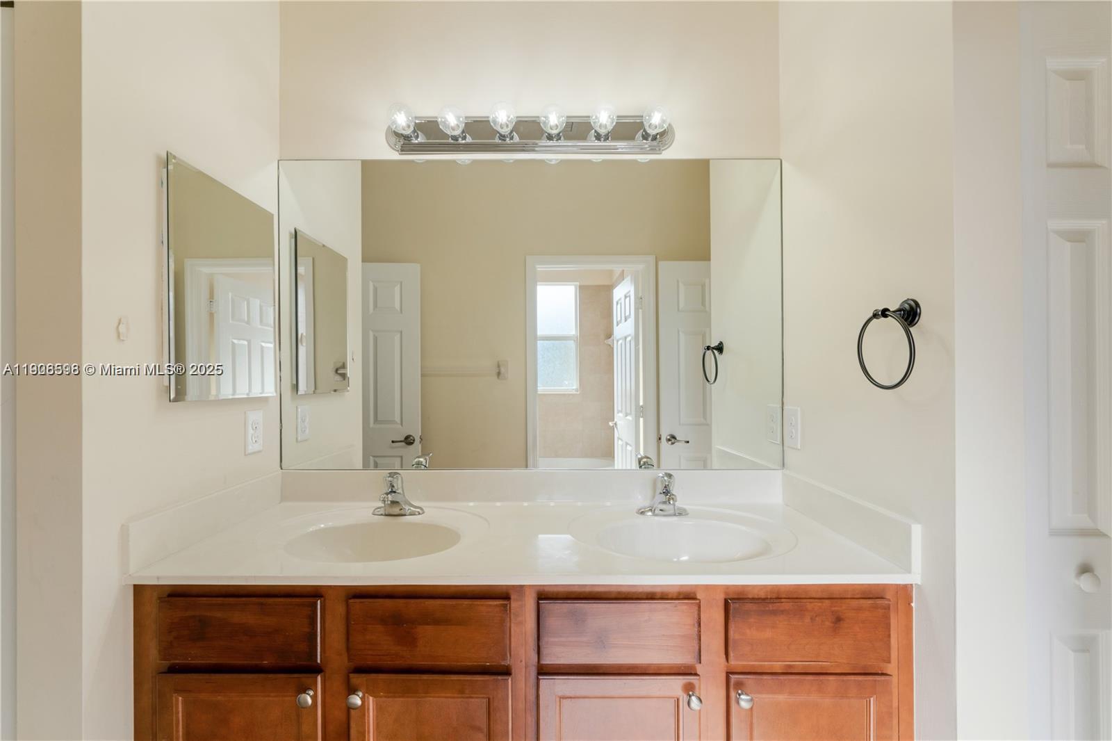 16946 Southwest 90th Terrace Circle Miami, FL 33196 - Photo 24 of 36 a bathroom with a granite countertop sink a mirror and shower