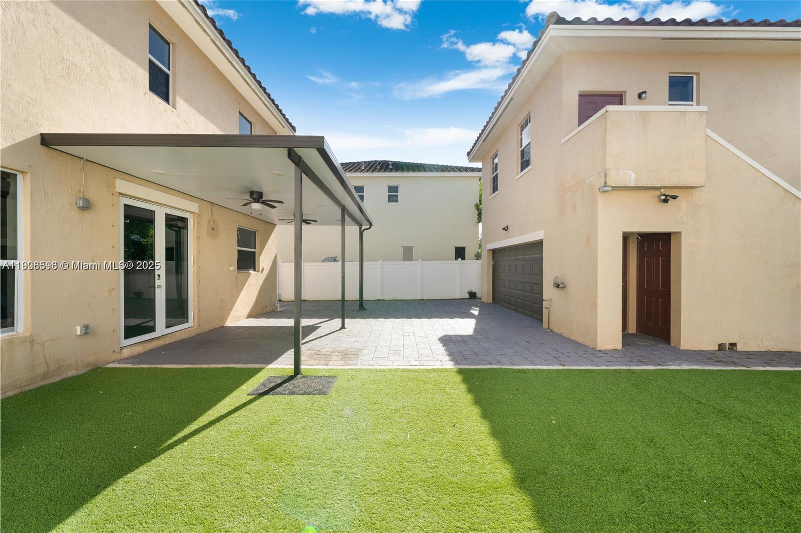 16946 Southwest 90th Terrace Circle Miami, FL 33196 - Photo 27 of 36 a view of an house with backyard and a floor to ceiling window