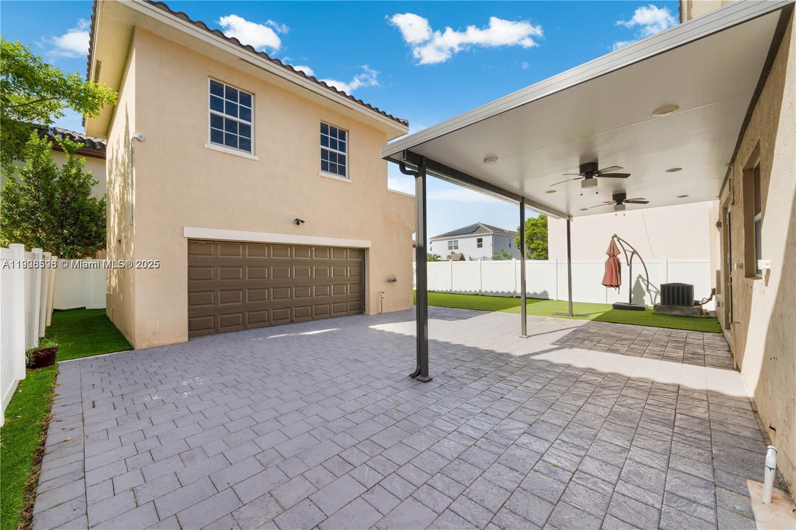 16946 Southwest 90th Terrace Circle Miami, FL 33196 - Photo 28 of 36 a view of a house with a patio and a yard