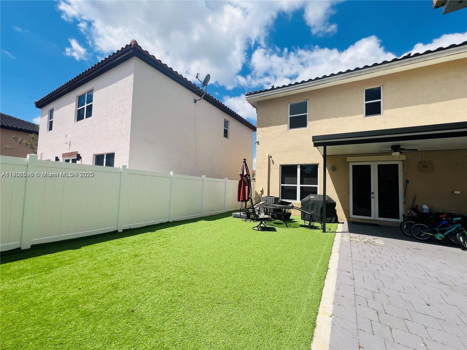 16946 Southwest 90th Terrace Circle Miami, FL 33196 - Photo 30 of 36 a view of a backyard with a sitting area and garden