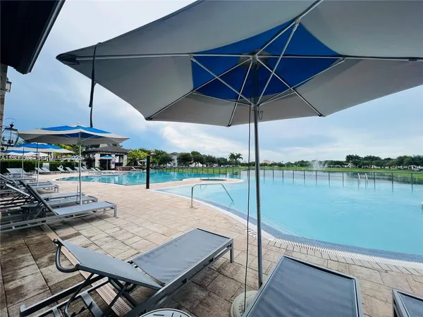 a view of a big building next to a lake with houses