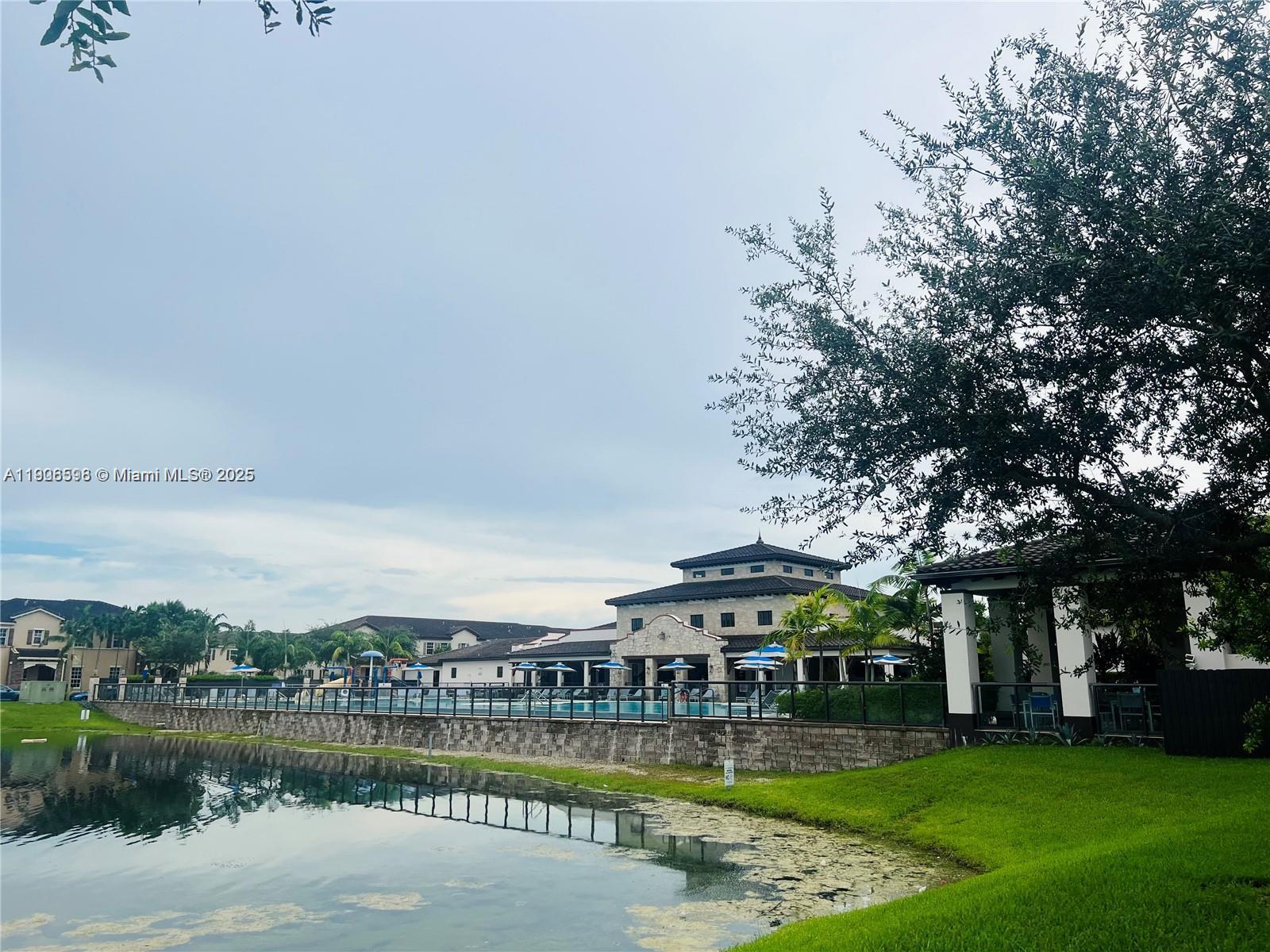 16946 Southwest 90th Terrace Circle Miami, FL 33196 - Photo 36 of 36 a view of a big building next to a lake with houses