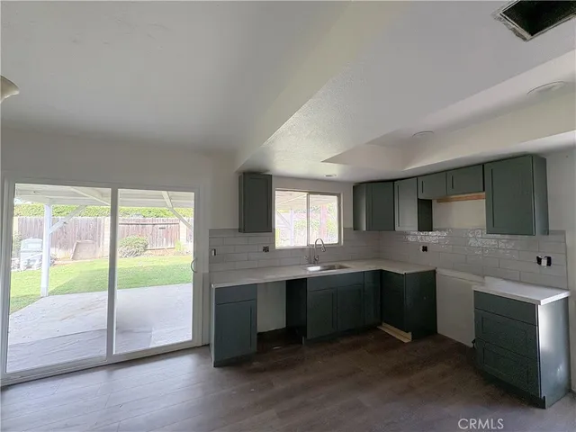 a large white kitchen with a large window