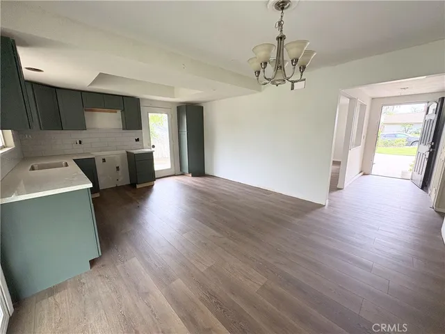 a view of a kitchen with a dishwasher cabinets and wooden floor