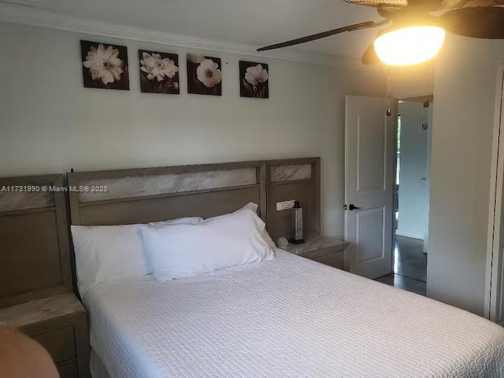 a bedroom with a bed and painting on the wall