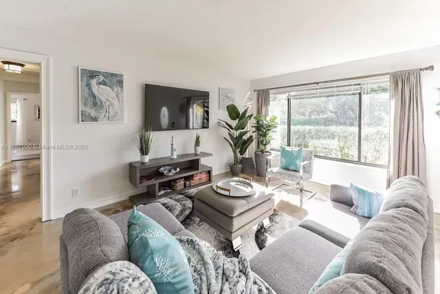a living room with furniture and a large window
