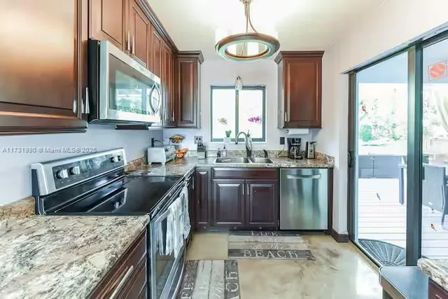 a kitchen with a stove sink and cabinets