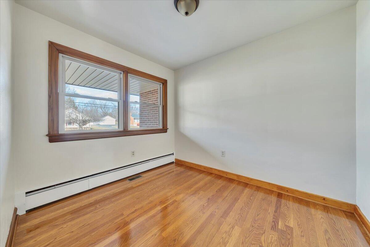 517 Boxley Road Roanoke, VA 24019 - Photo 28 of 76 a view of an empty room with wooden floor and a window