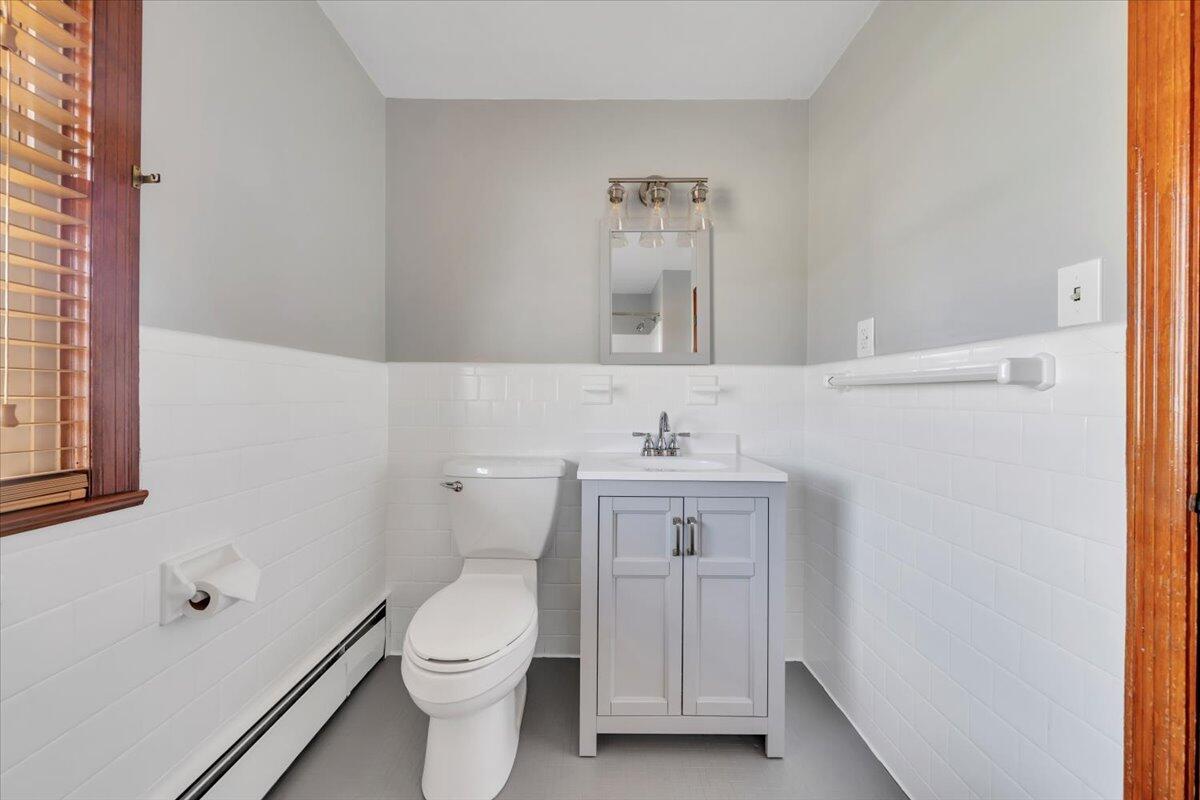 517 Boxley Road Roanoke, VA 24019 - Photo 45 of 76 a bathroom with a toilet a sink a vanity and mirror