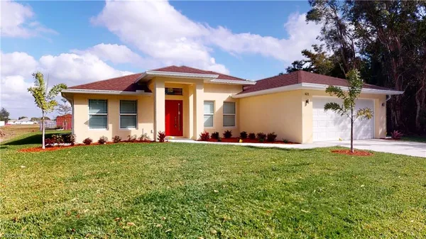 a front view of house with yard and outdoor seating